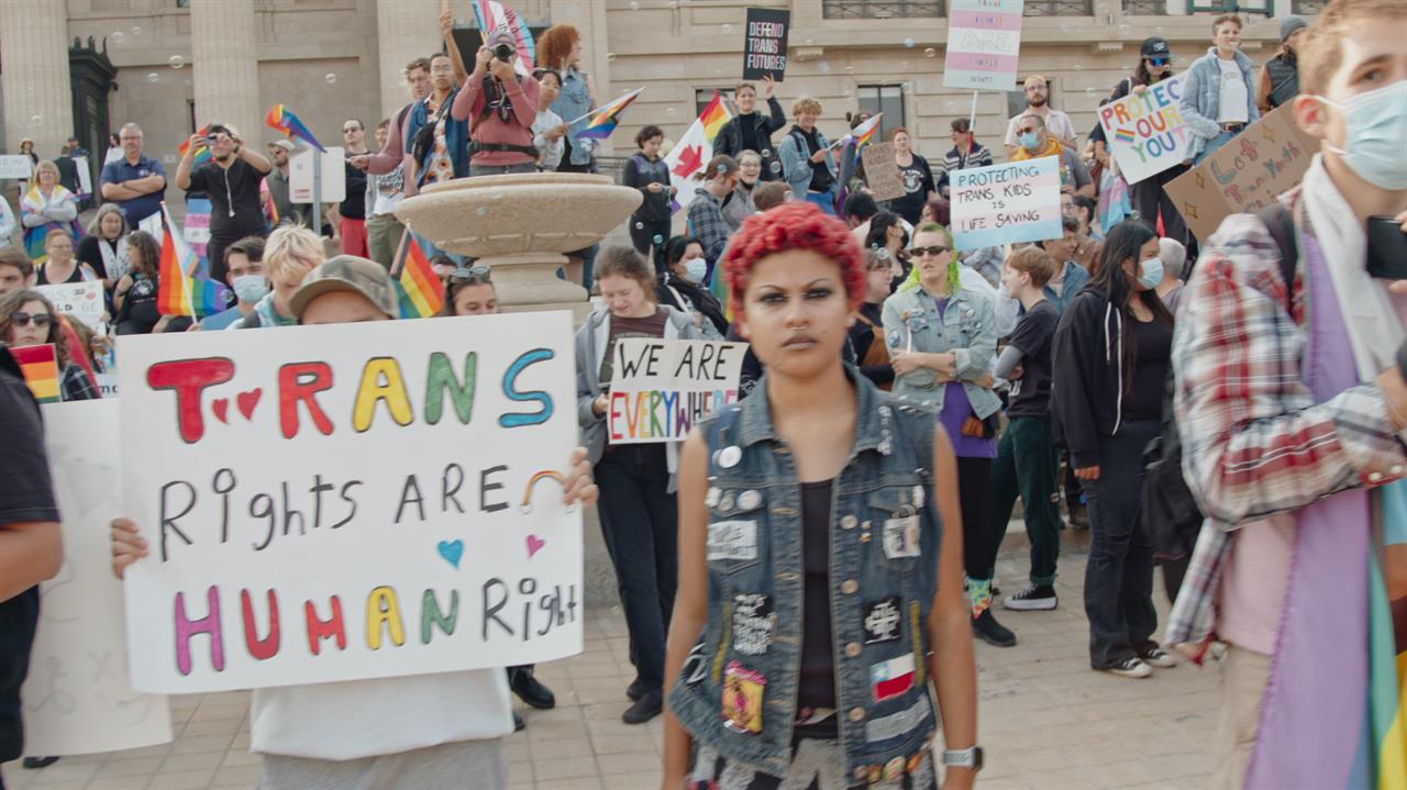 a person in a denim vest in front of a crowd