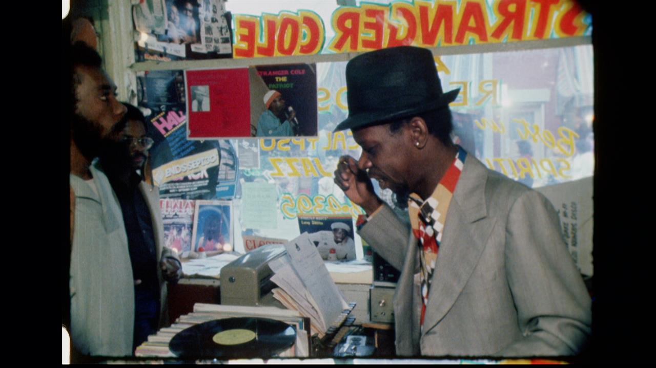 three men talking in a record shop