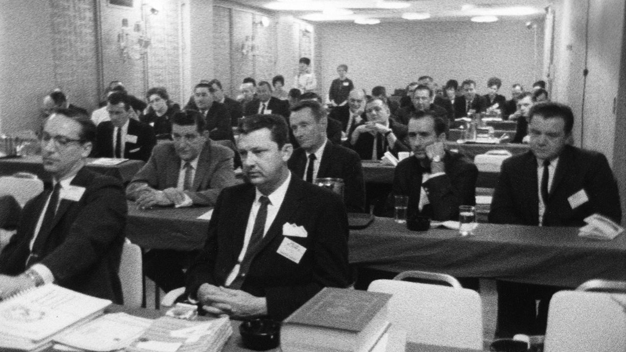 a group of salemen in suits sitting together