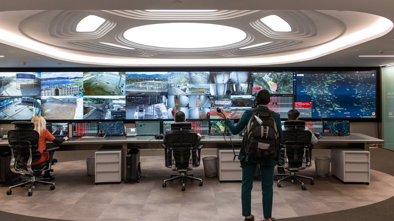 a group of people in front of multiple screens