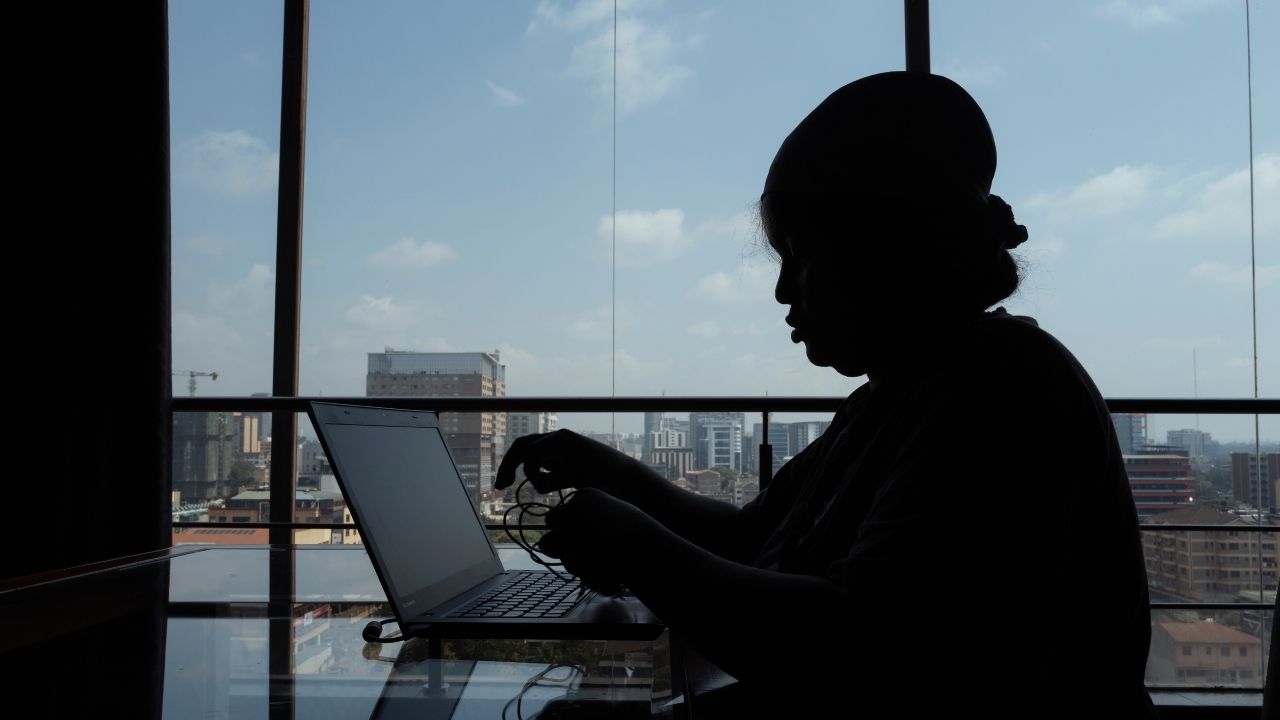 silhouette of a person on a laptop