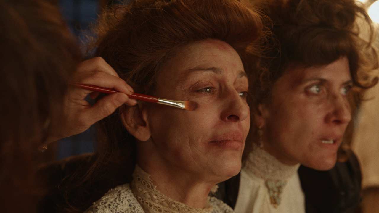 a woman getting makeup applied on her face