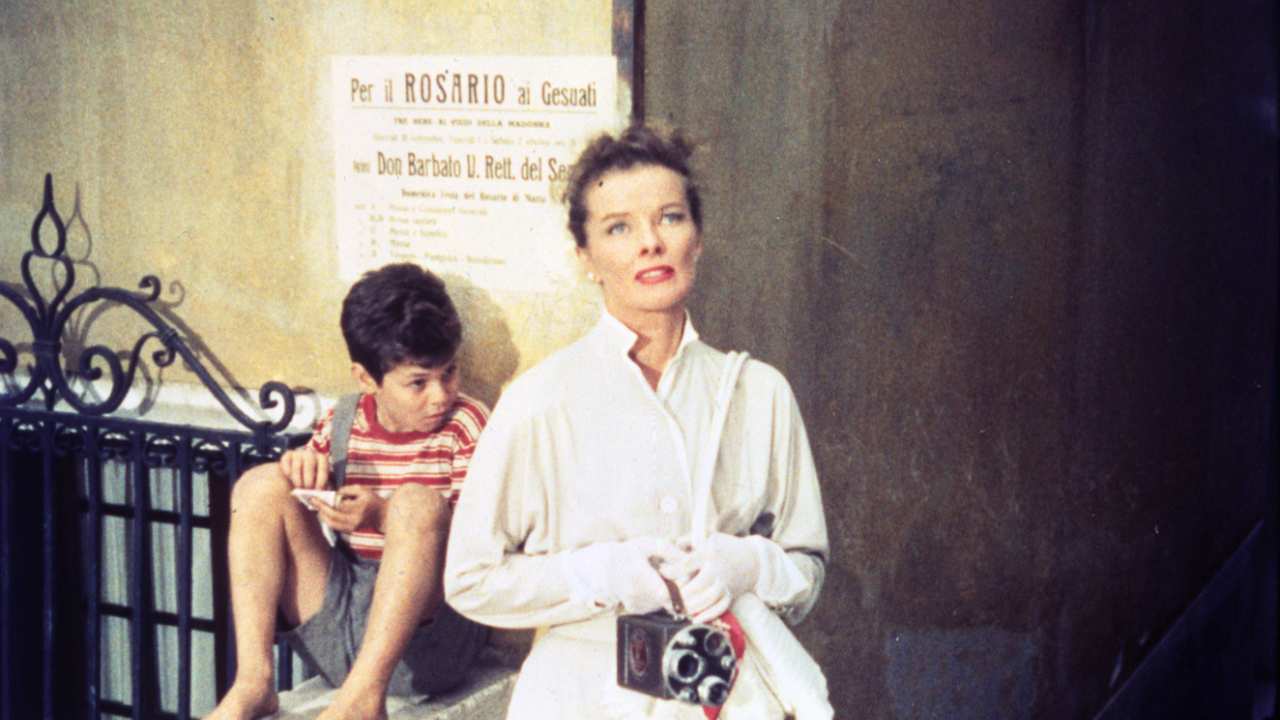 Katherine Hepburn next to a boy in a striped shirt