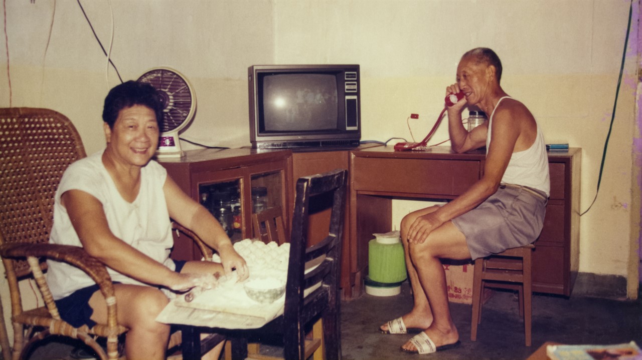 a man and woman sitting in a living room