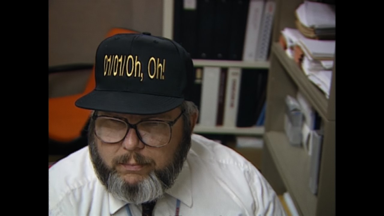 A man in a baseball cap that says 01/01/Oh, Oh!