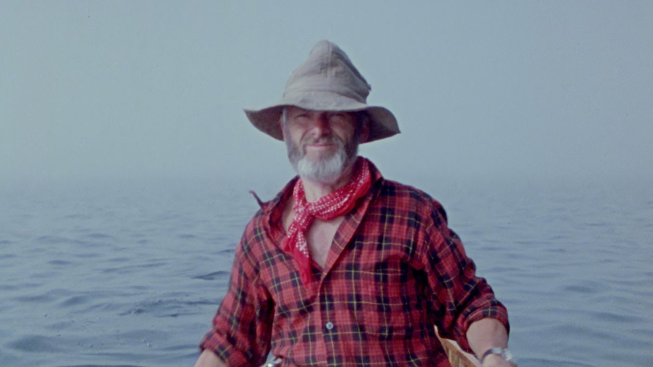a bearded man with bucket hat in plaid