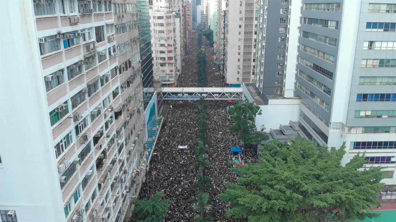 Aerial view of a street full of people surrounded 