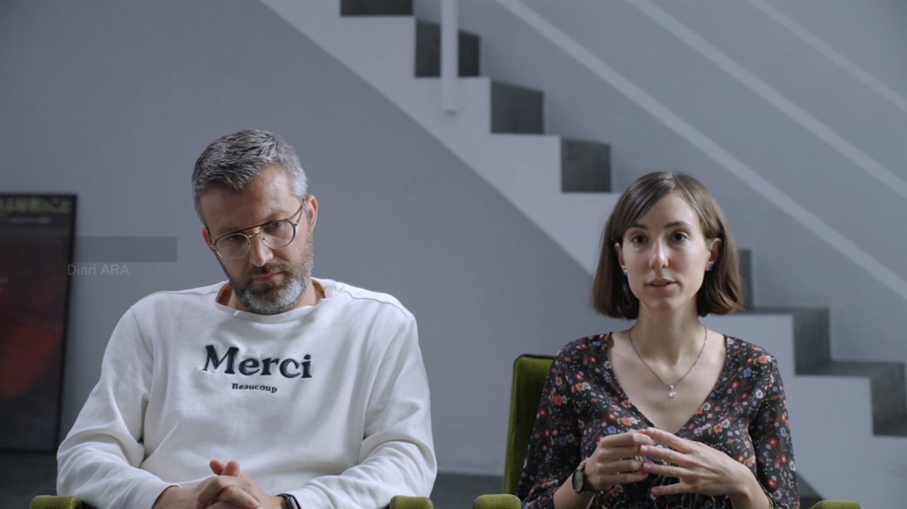 A man and a woman sitting beside each other