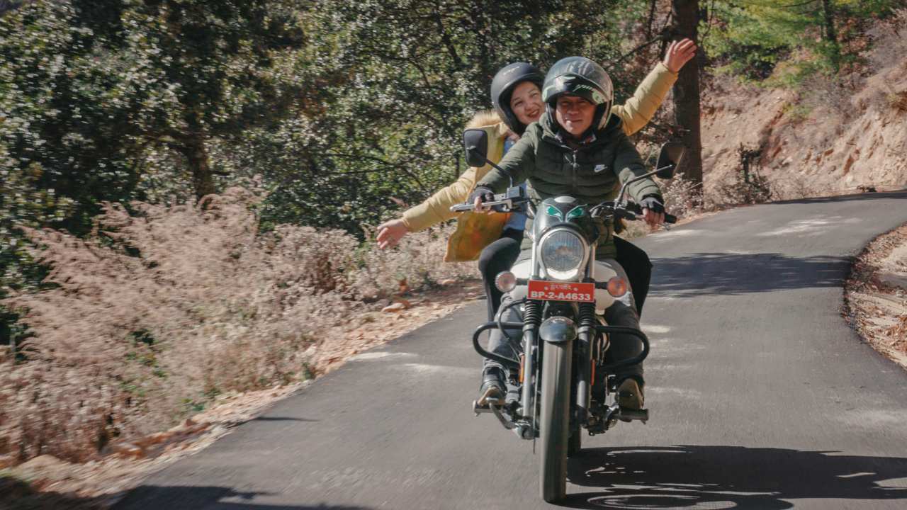 a man and woman on a motorcycle