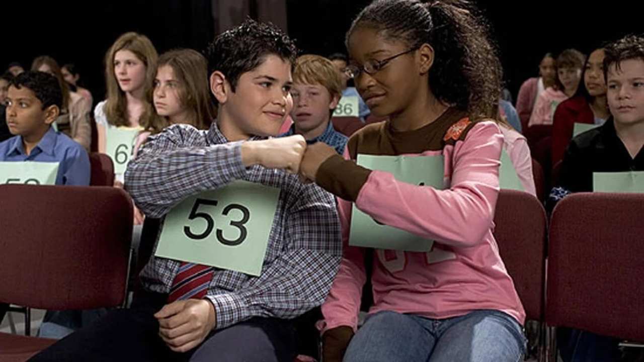 a young boy and girl fist pumping each other