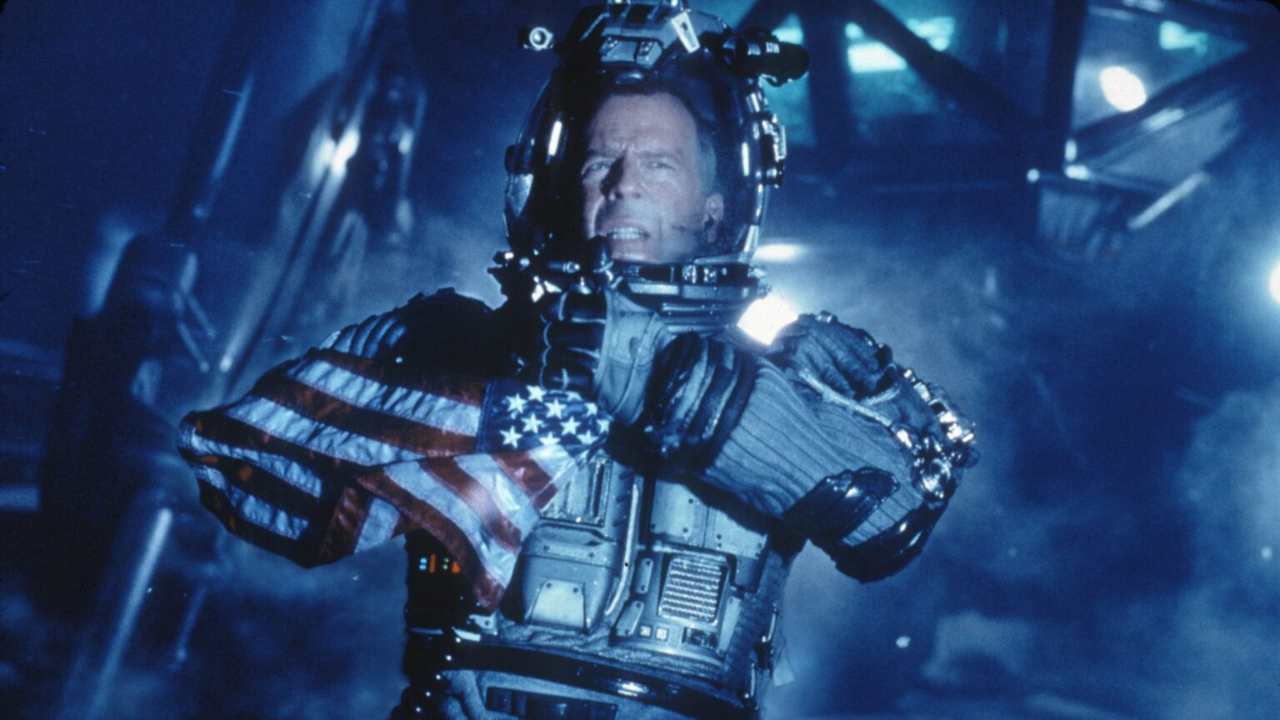 Bruce Willis in a full body suit and helmet