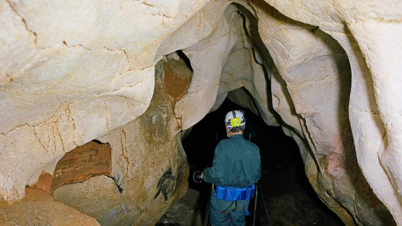 a person going down into a cave