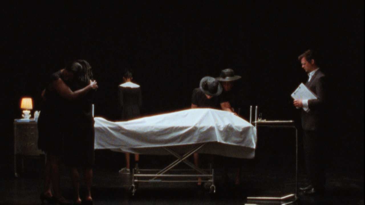 a group of people in black mourning a person