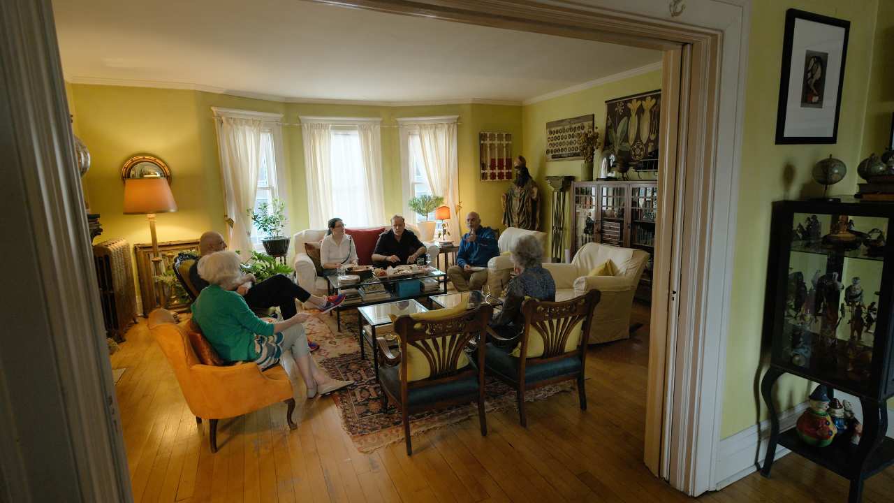 a group of people sitting in a living room