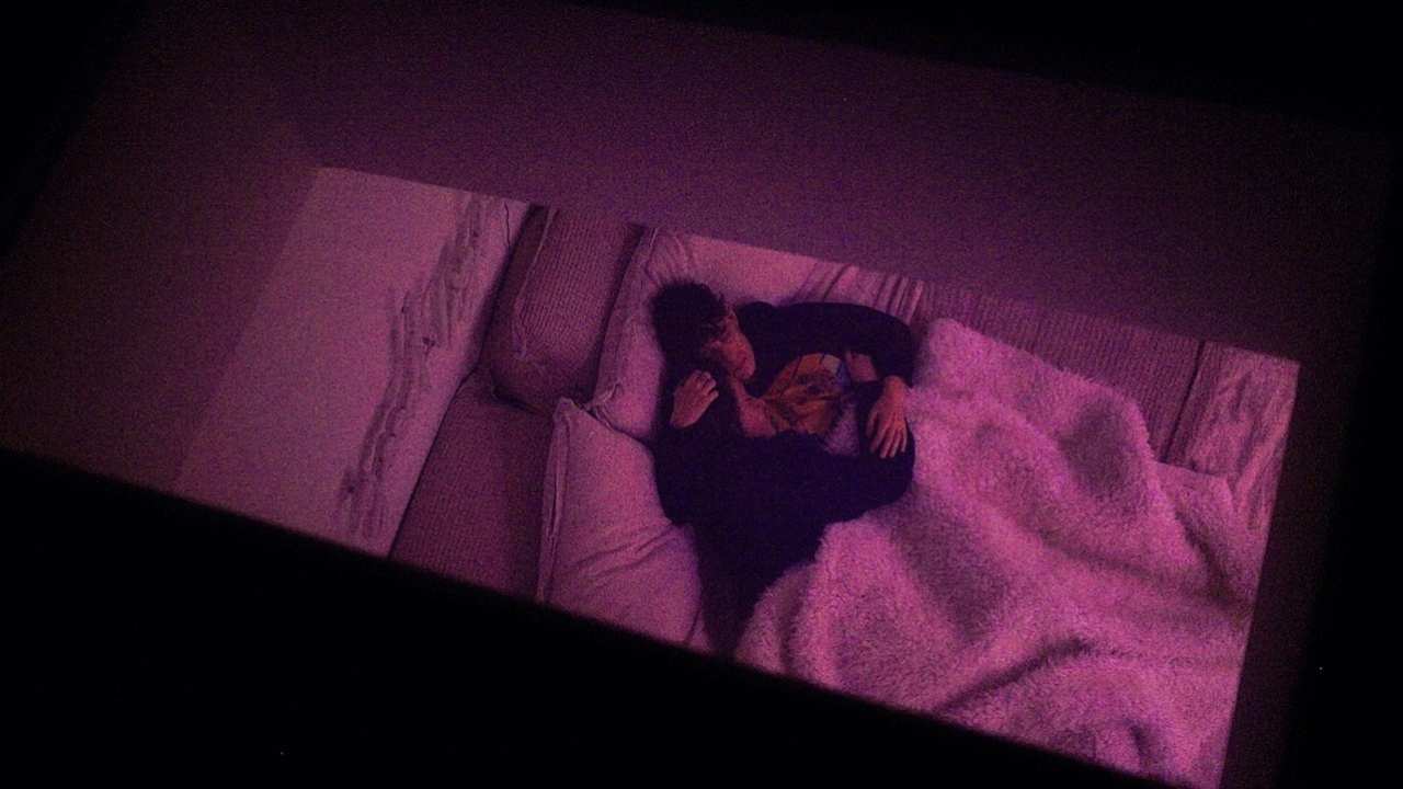 two people holding each other in bed