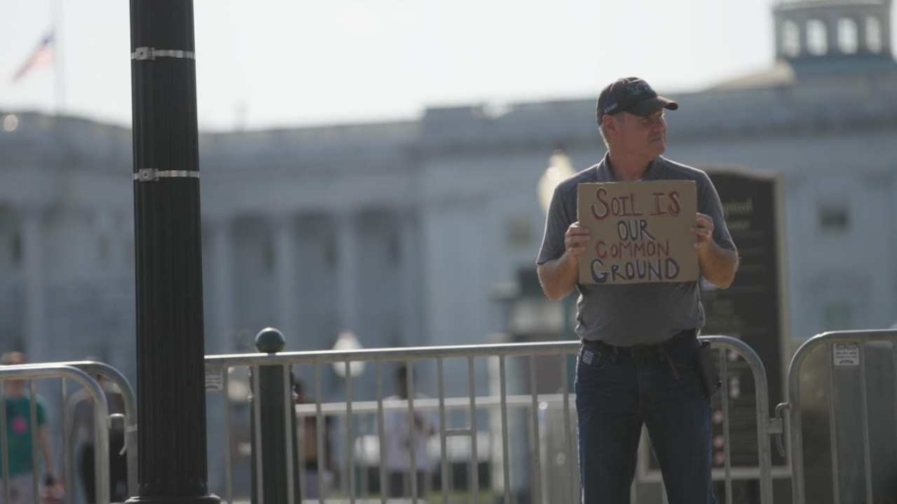 a man holding a sign on the street