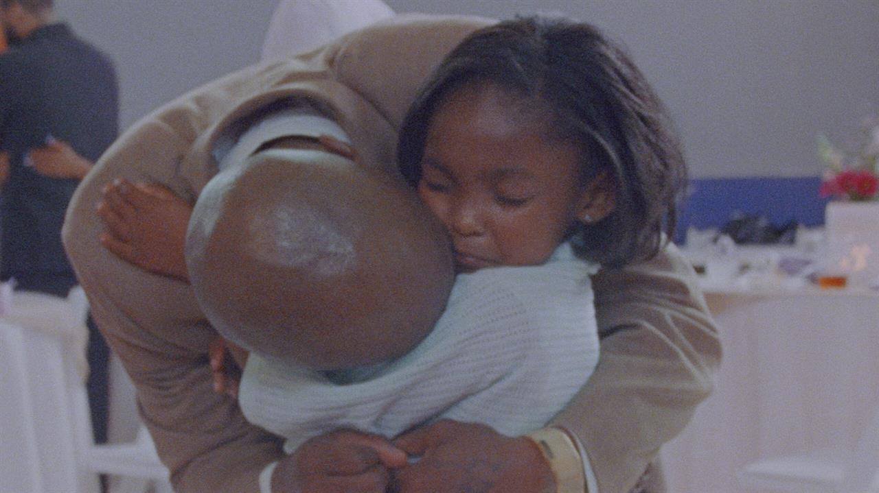 A little girl hugs her father