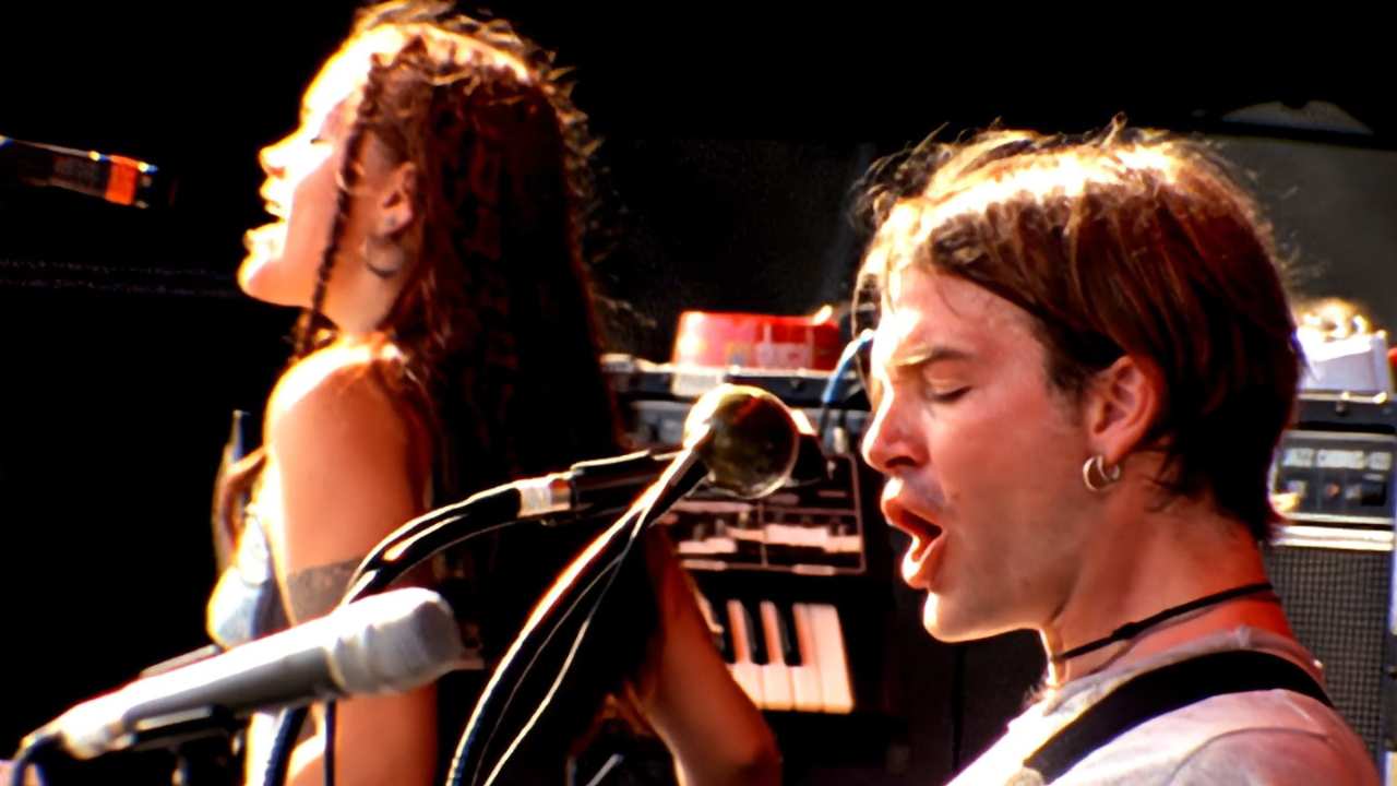 a woman and man singing into microphones