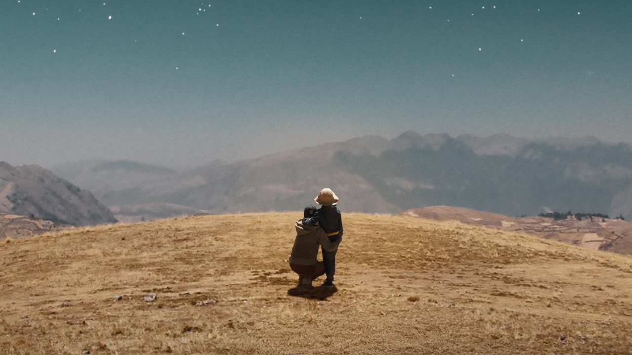 a person & child looking at the horizon together