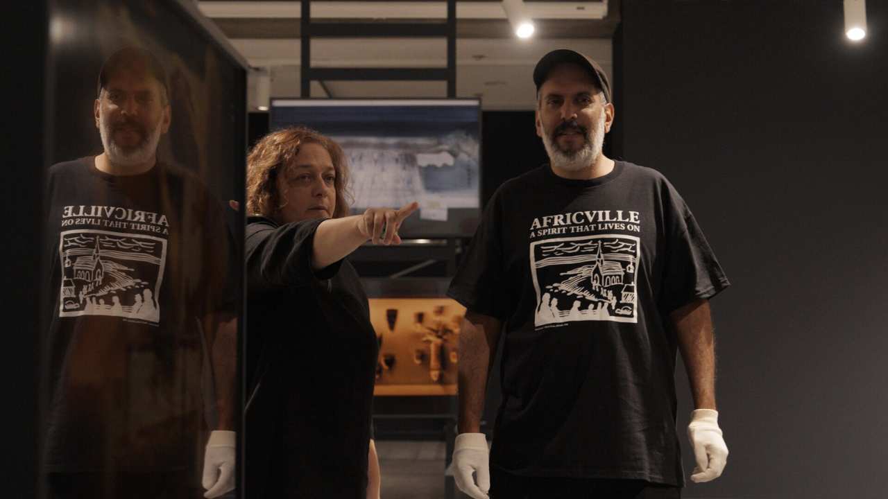 a woman pointing next to a man with a beard