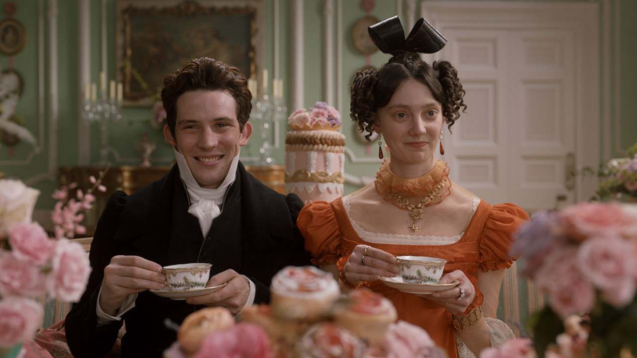 a man and a woman smiling and drinking tea