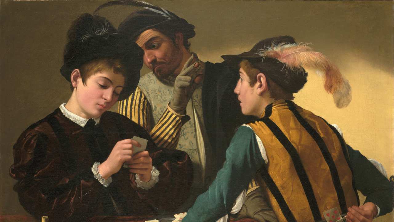 a man & 2 boys playing cards in feathered hats
