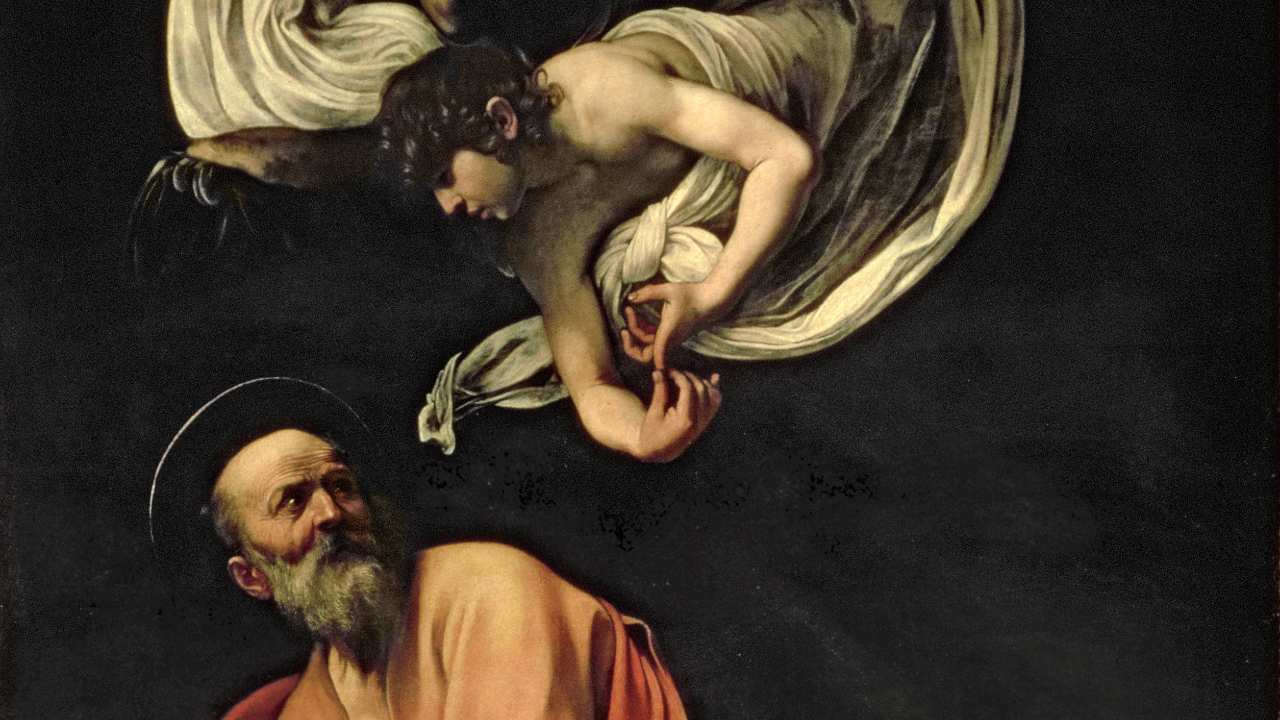 a bearded man looking up at an angel