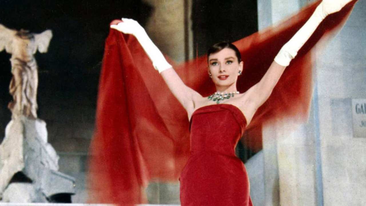 Audrey Hepbrun in a red dress with white gloves