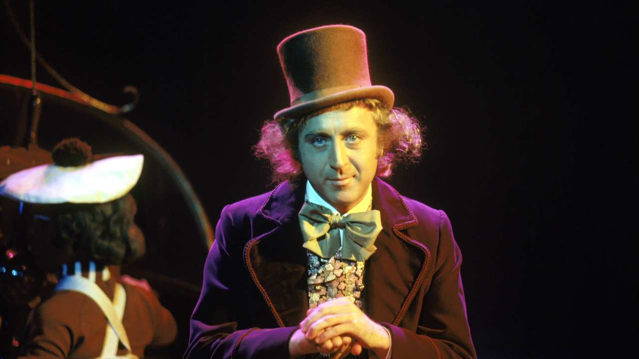 A man dressed up with a top hat and fun coloured l