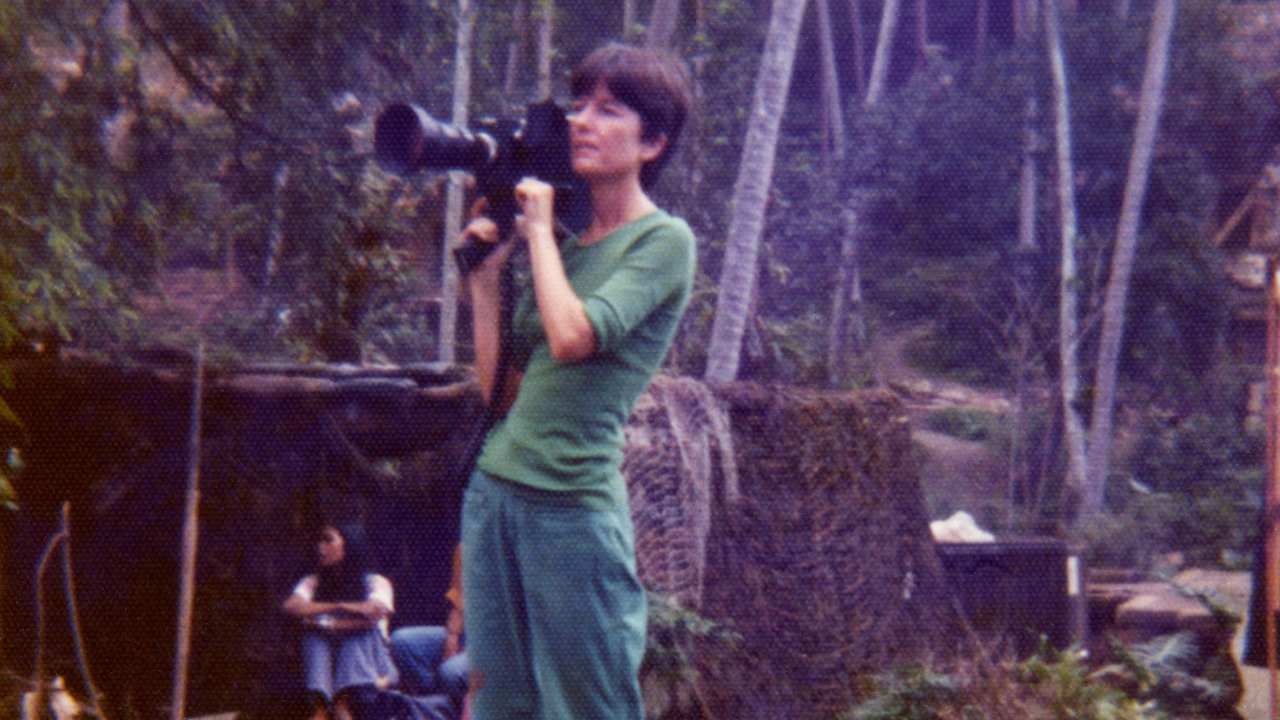 a woman holding a movie camera