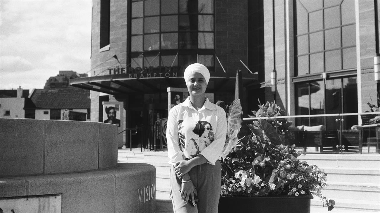 Woman stands outside of a modern building