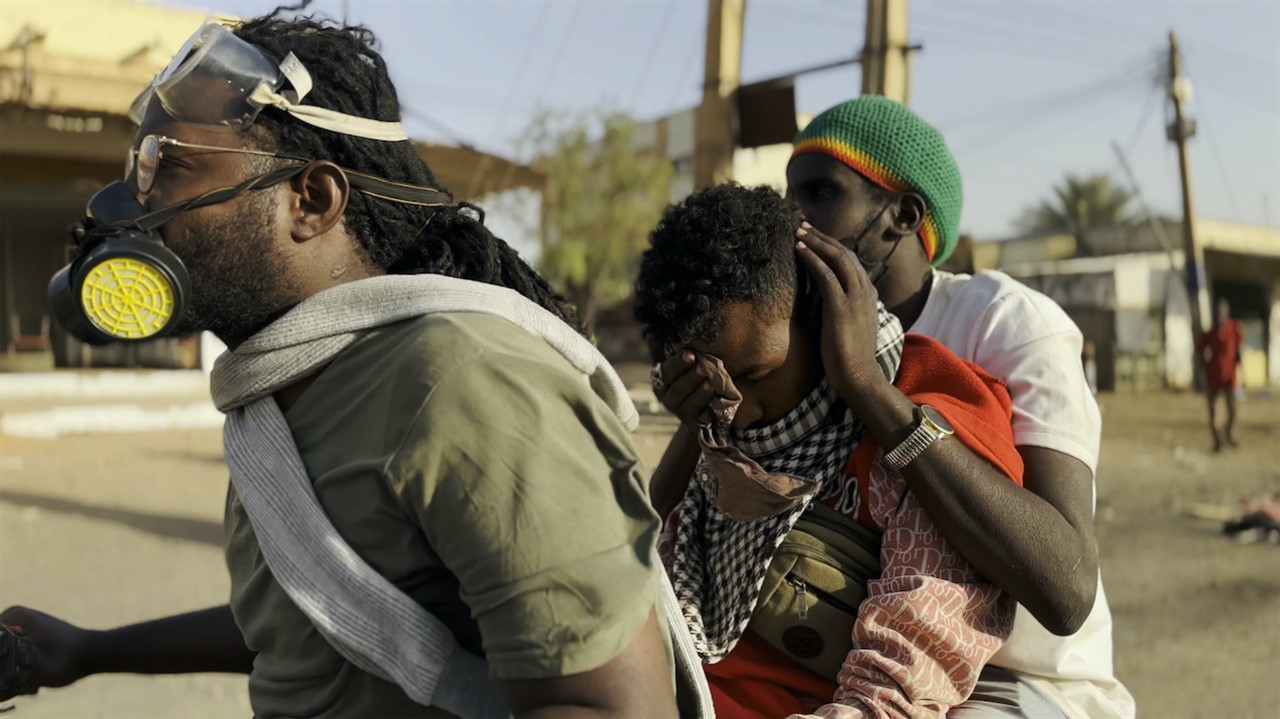 three people wearing respiratory masks
