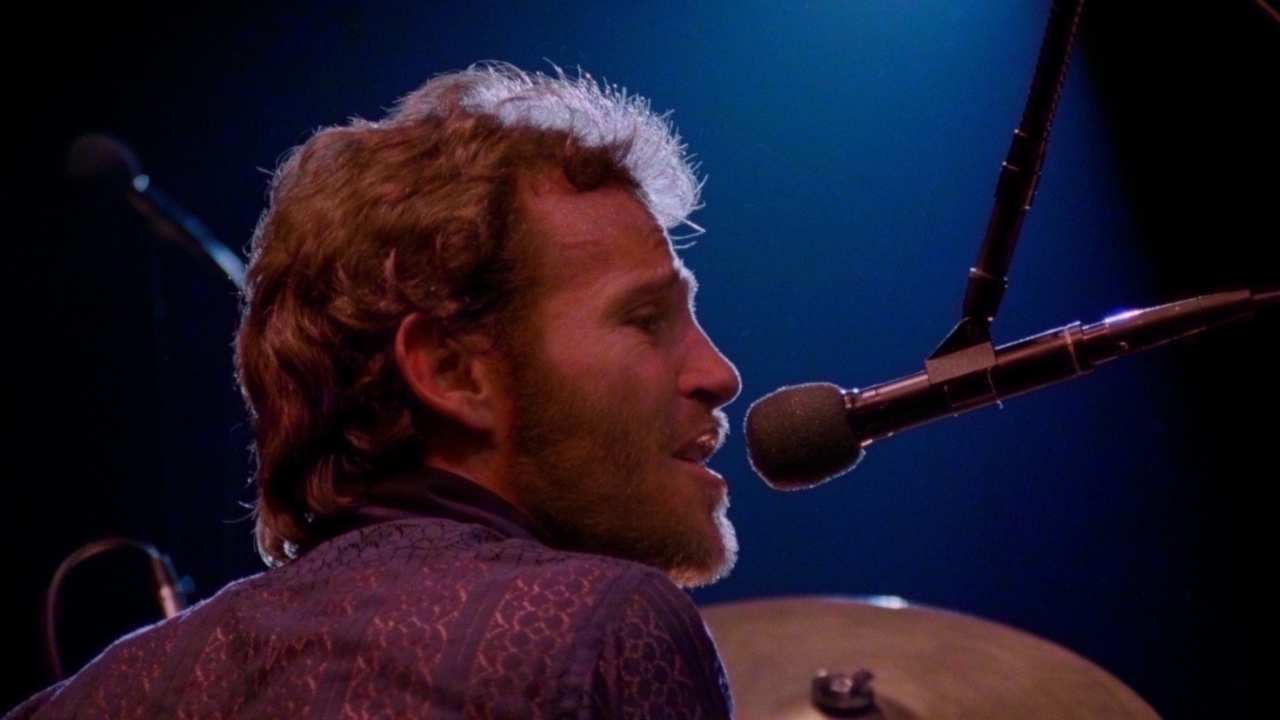 a man singing into a microphone