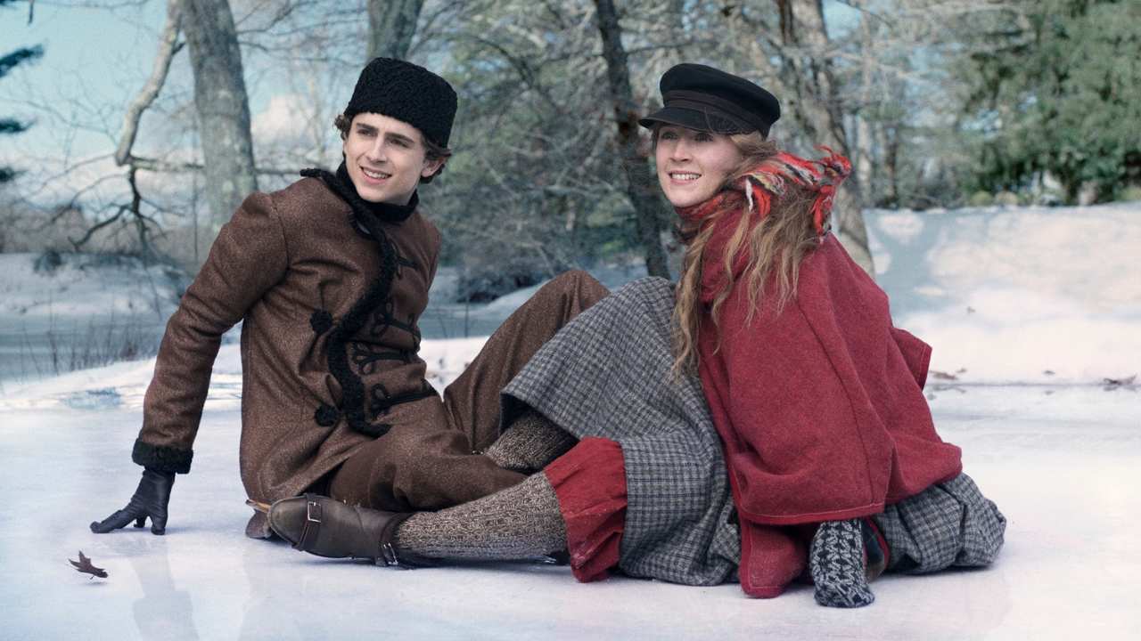 a man and woman sitting together in the snow