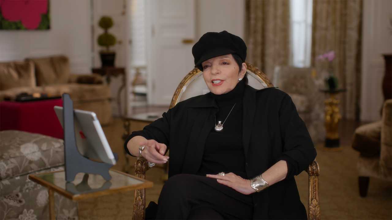 Liza Minelli sitting in a chair