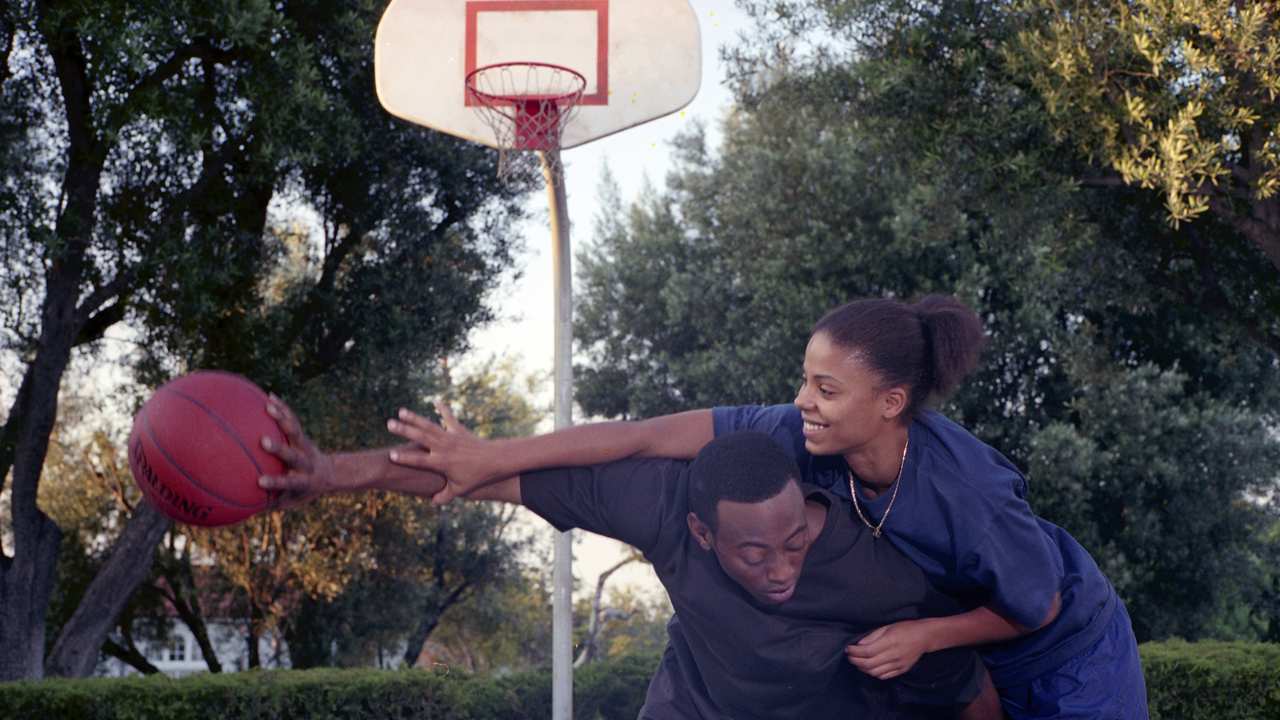 a man and a woman playing basketball