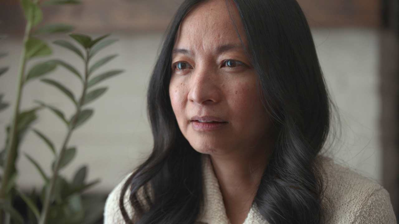 a woman talking next to a plany