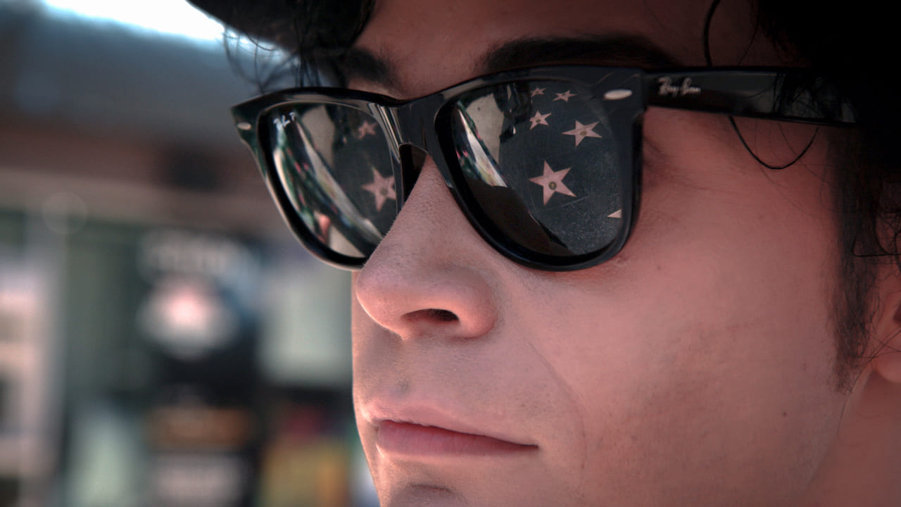 Closeup of face with sunglasses reflecting stars