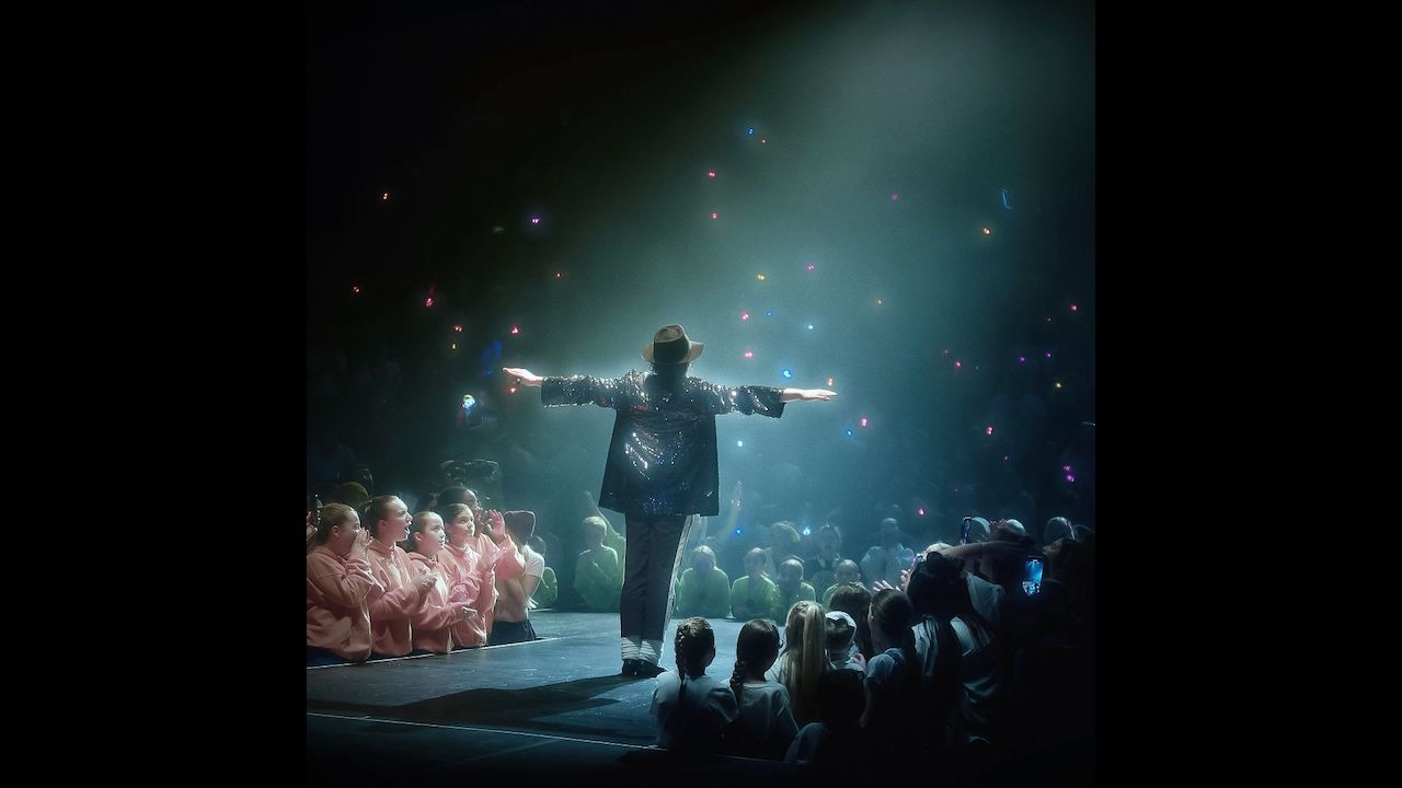 Michael Jackson on stage surrounded by fans