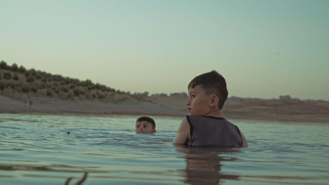 two children swimming together