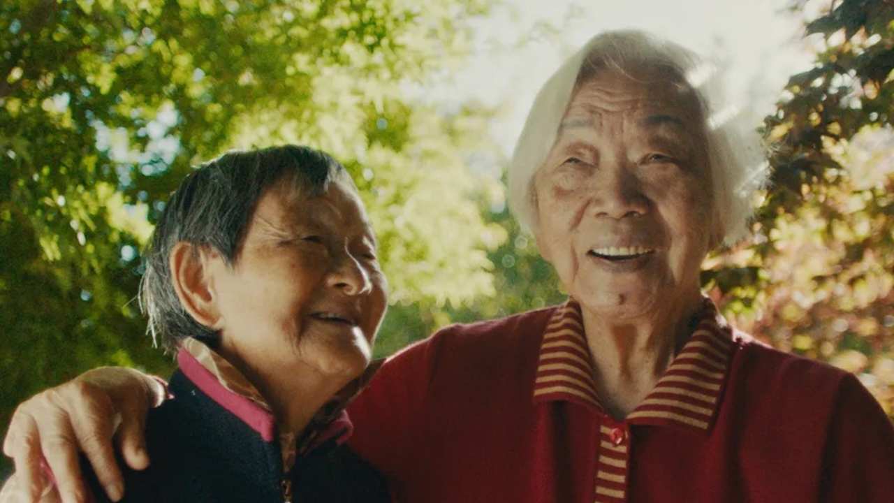 two women standing together and smiling