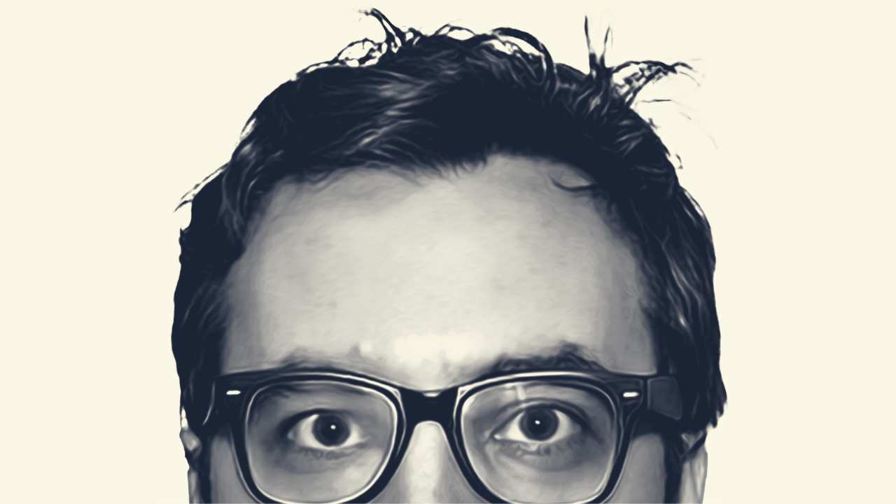 the top half of a man's face with glasses