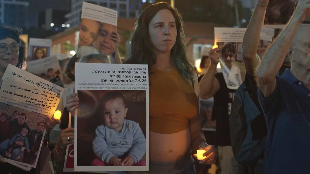 a group of people holding up signs of children