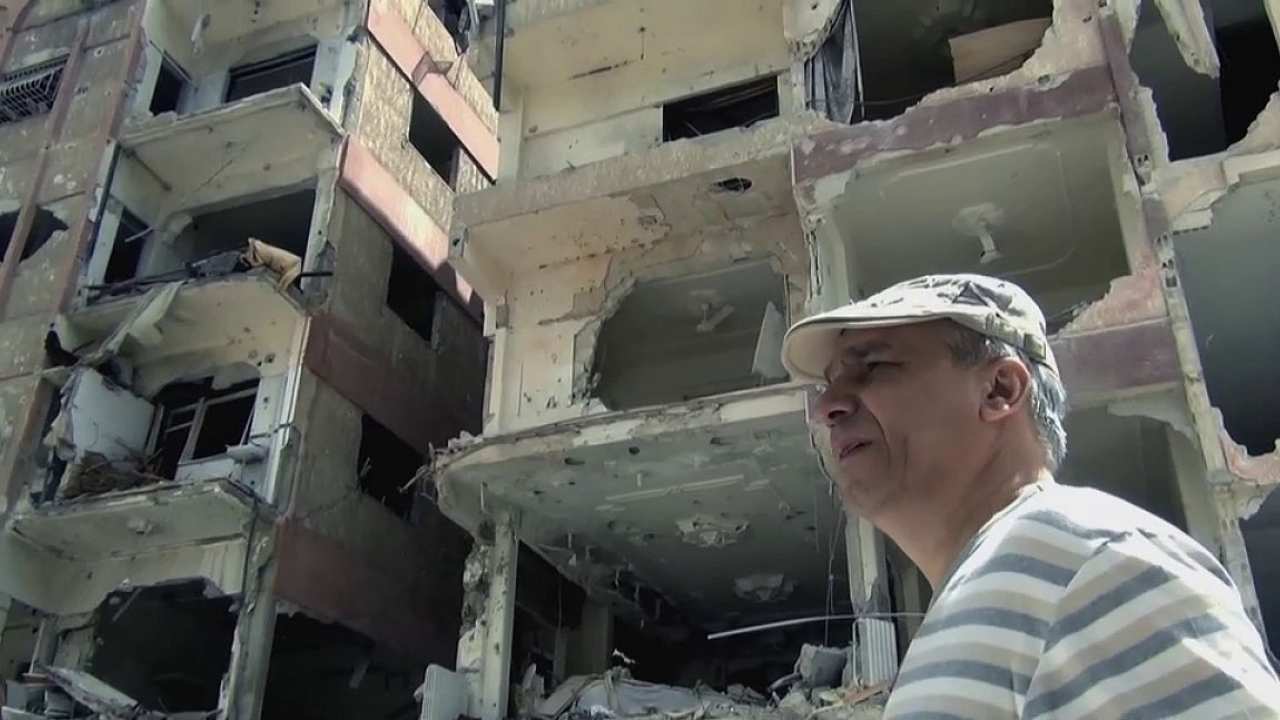 a man walking by a demolished building