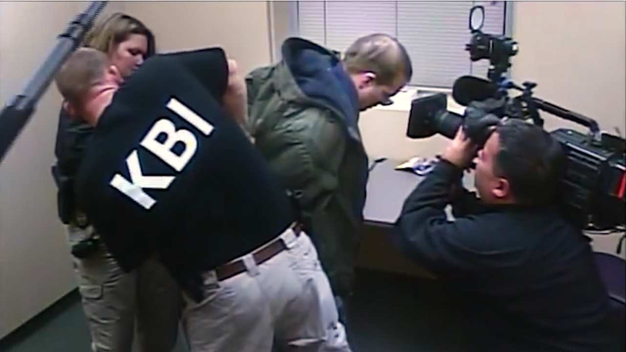 a man being arrested by the FBI and filmed