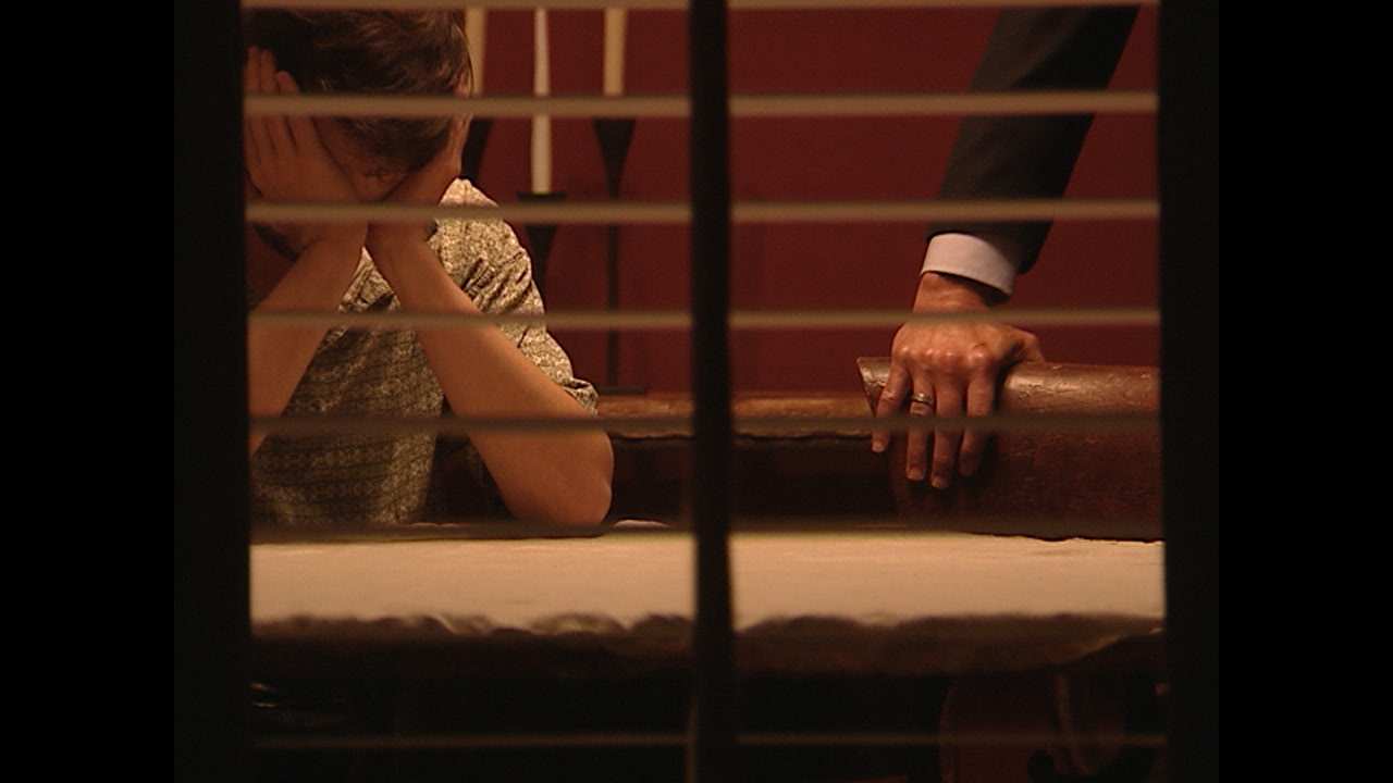 a person holding their head in their hands