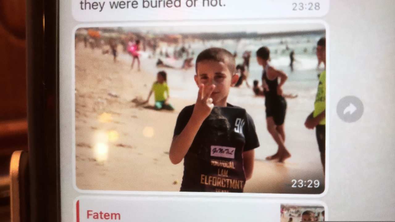 a little boy holding up his fingers on a phone