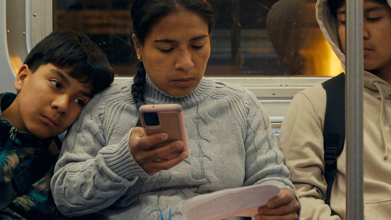 a woman checking her phone with her son