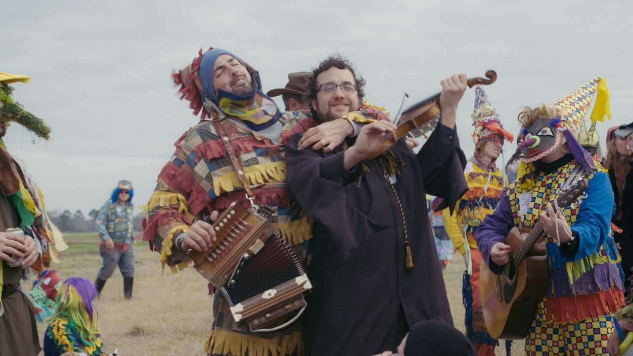 a group of people playing music in bright costumes
