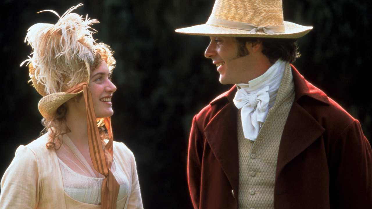 a woman and man with elegant hats smiling